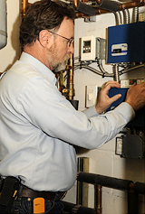 Terry Hipple checking boiler heating system during home inspection